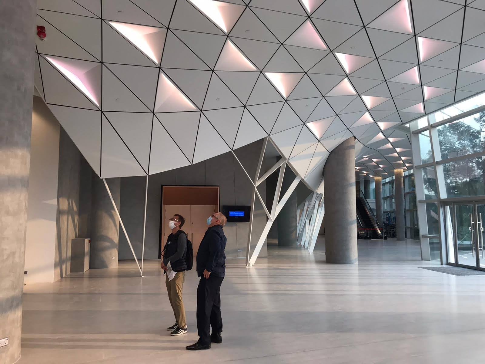 Completed foyer showing the triangular ceiling matrix and branching columns