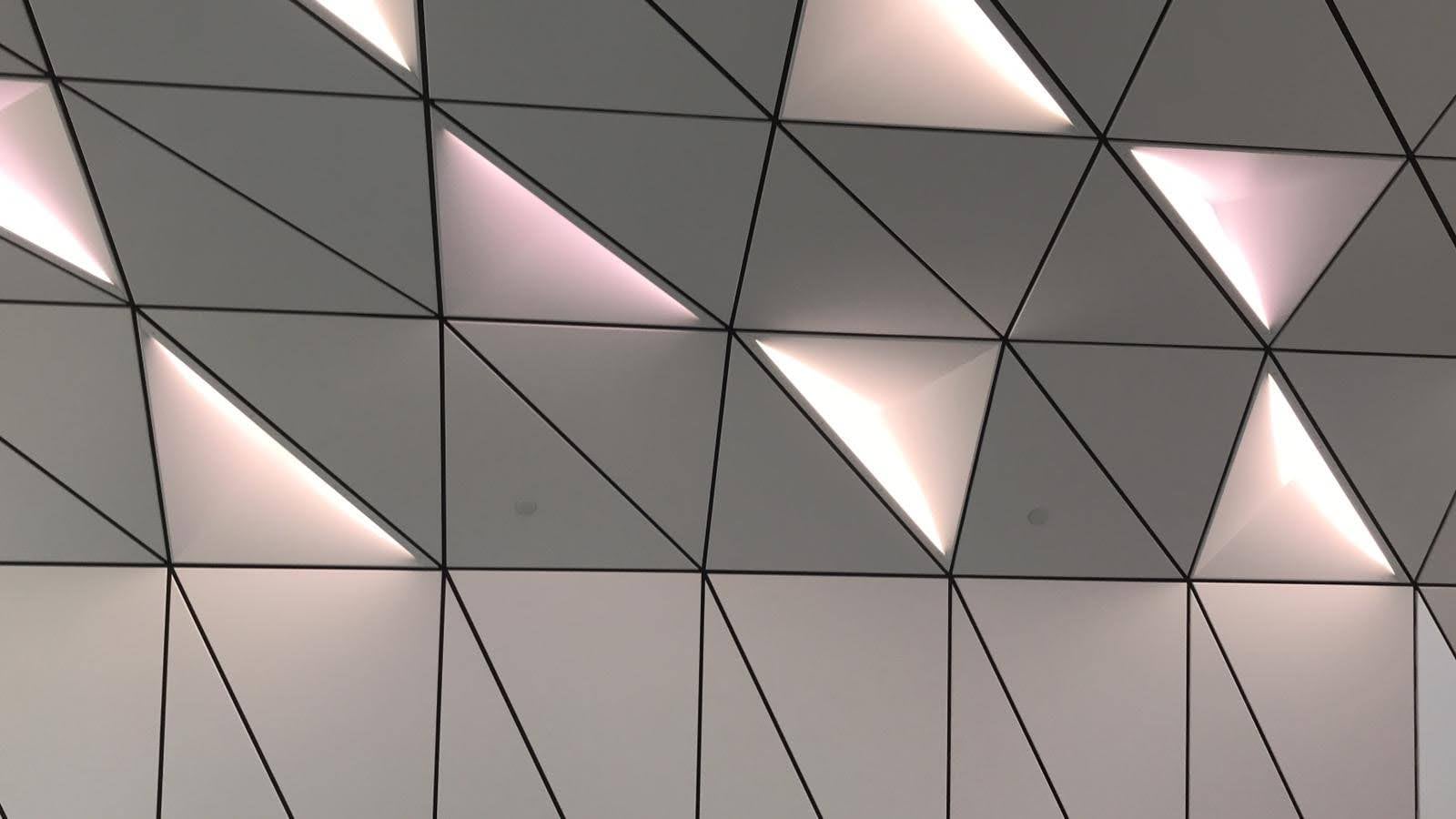 Close view of the illuminated triangular aluminium ceiling panels
