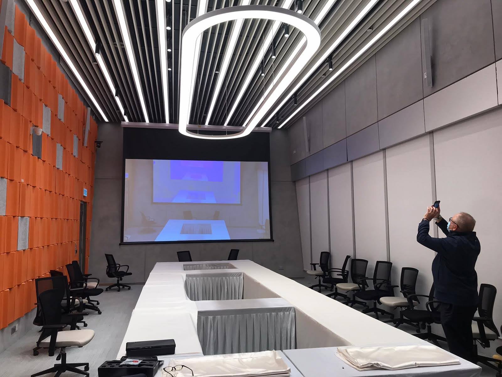 Completed screening room with acoustic wall panels and integrated linear lighting
