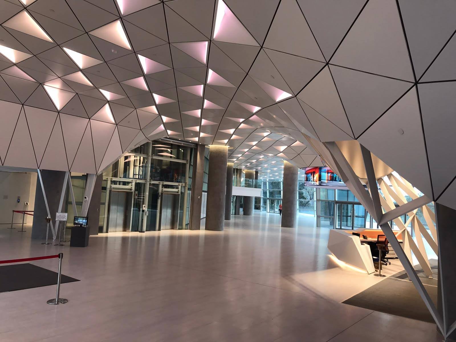 Completed Shaw Movie City foyer with a geometric ceiling and branching structural supports